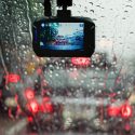 A dashboard camera is placed just below a rear-view mirror