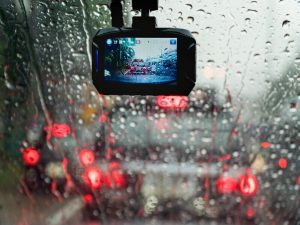 A dashboard camera is placed just below a rear-view mirror