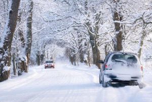 A car driving down a snow street