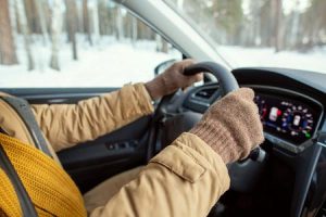 A man drives a car amid winter weather