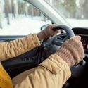 A man drives a car amid winter weather