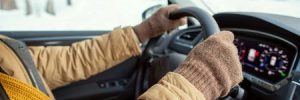 A man drives a car amid winter weather