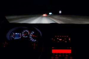 View of a person driving on the highway at night